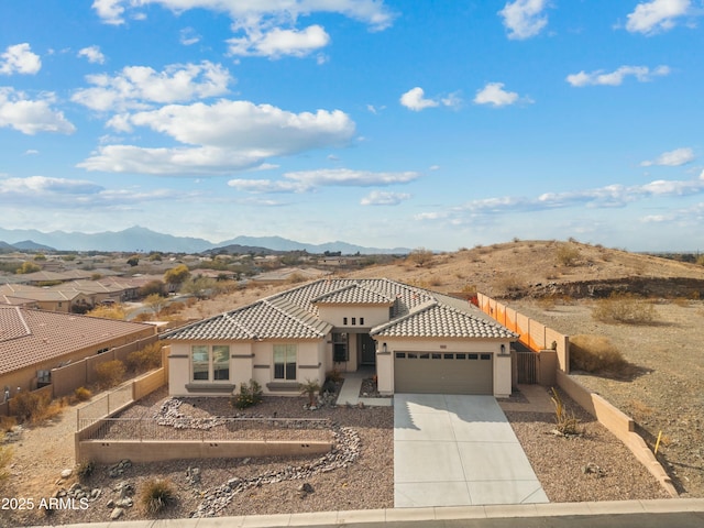 view of front facade with a garage and a mountain view