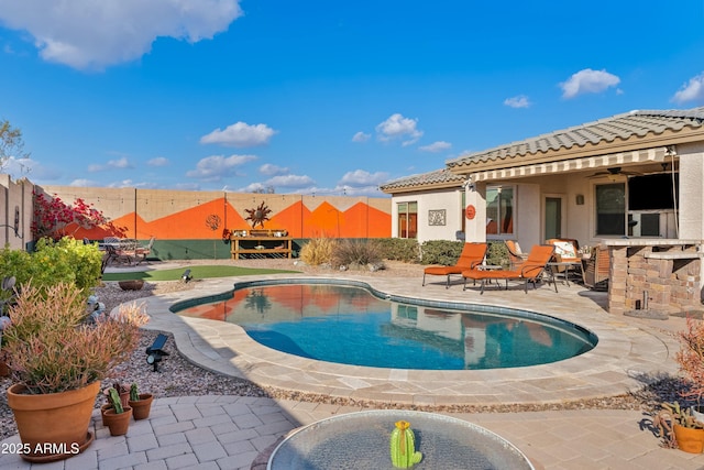 view of swimming pool featuring a patio and ceiling fan