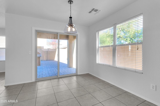 unfurnished dining area with light tile patterned floors