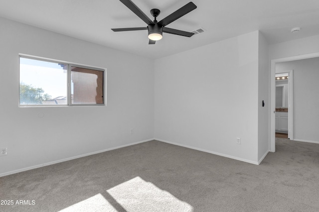 empty room featuring light colored carpet and ceiling fan