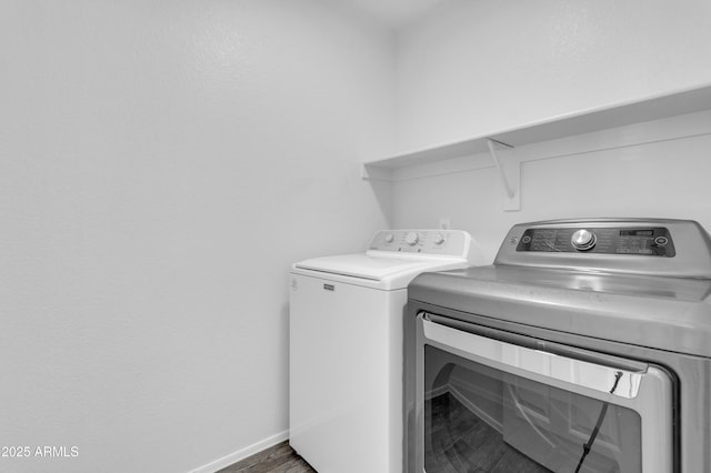 washroom with washer and dryer and dark hardwood / wood-style flooring