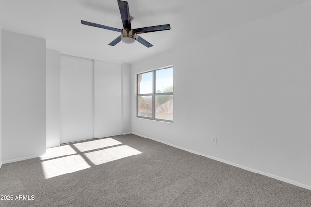 carpeted empty room featuring ceiling fan