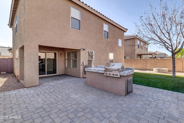 rear view of property featuring a yard and a patio