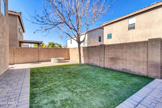 view of yard with a patio area and an outdoor fire pit