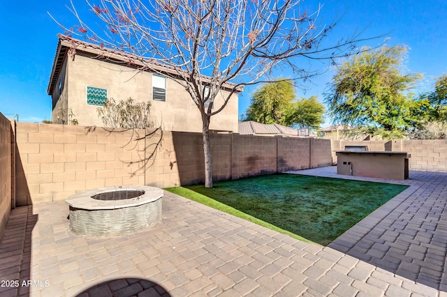 view of patio with a fire pit