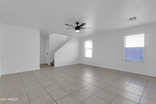 interior space featuring light tile patterned floors and ceiling fan