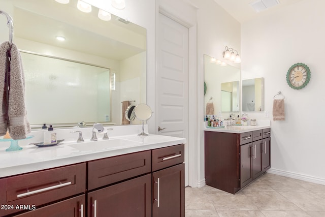 bathroom featuring vanity, tile patterned floors, and a shower with shower door