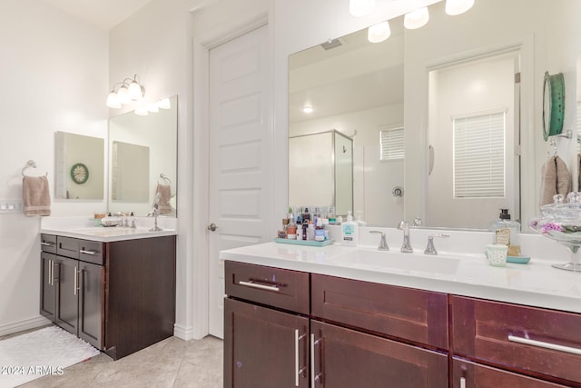 bathroom with vanity, an enclosed shower, and tile patterned floors