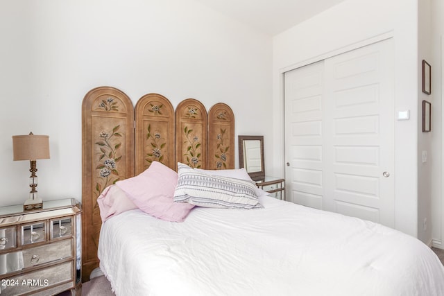 carpeted bedroom with a closet