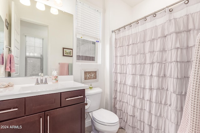 bathroom with vanity, toilet, and curtained shower