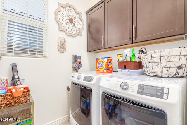 laundry area with cabinets and separate washer and dryer