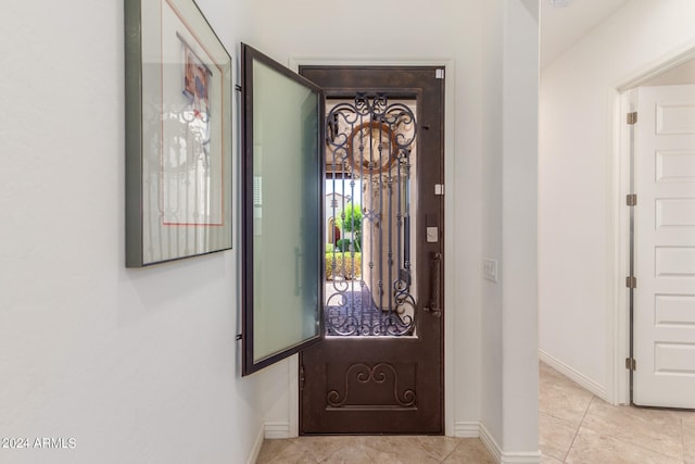 entryway with light tile patterned floors