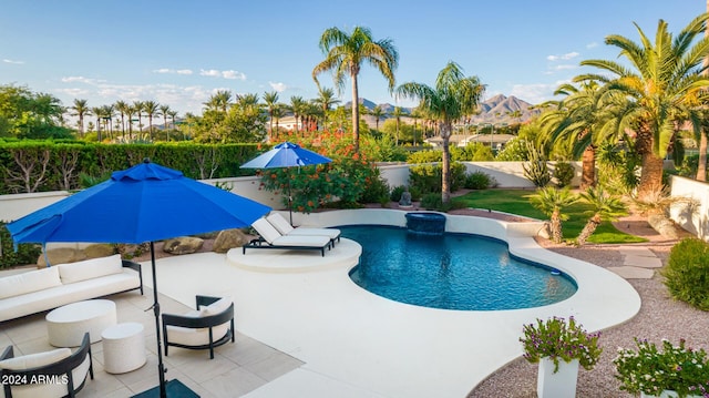 view of pool featuring a fenced in pool, a fenced backyard, a patio, and outdoor lounge area