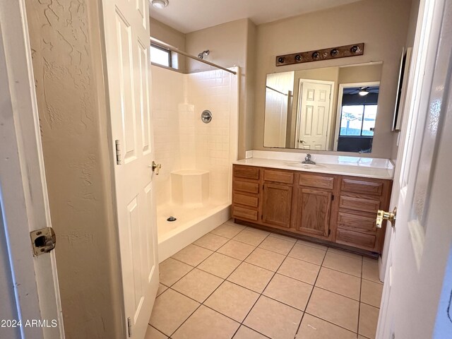 bathroom featuring vanity, a shower, and tile patterned flooring