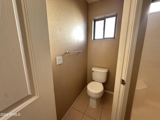 bathroom featuring toilet and tile patterned flooring