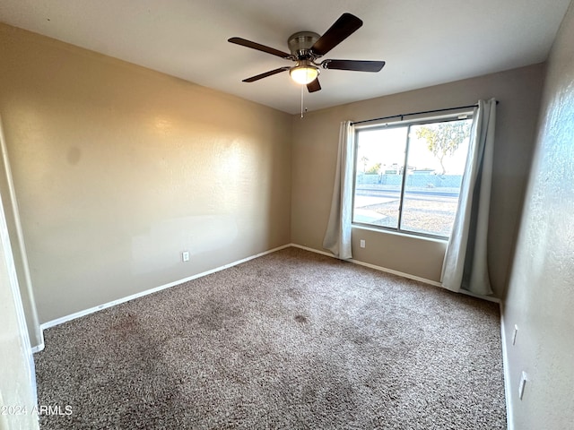 empty room featuring carpet floors and ceiling fan