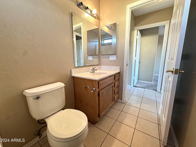 bathroom featuring toilet, tile patterned flooring, and vanity