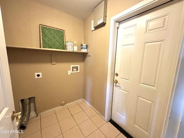 clothes washing area with hookup for an electric dryer, light tile patterned floors, and washer hookup