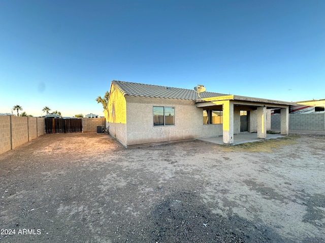 rear view of house featuring a patio and central AC