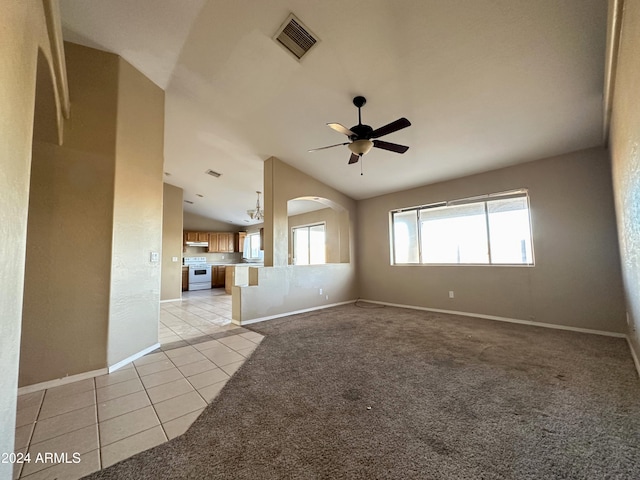 spare room featuring lofted ceiling, ceiling fan, and light tile patterned flooring