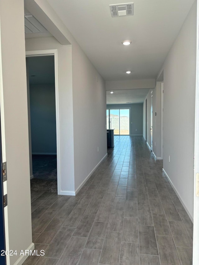 corridor with hardwood / wood-style floors