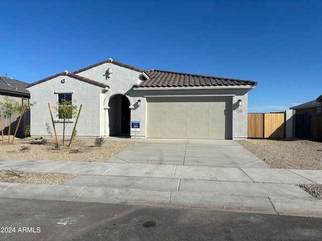 mediterranean / spanish house featuring a garage