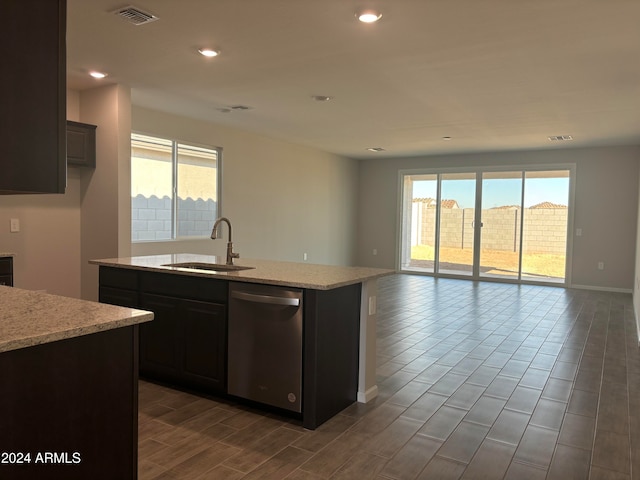 kitchen with a center island with sink, stainless steel dishwasher, plenty of natural light, and sink