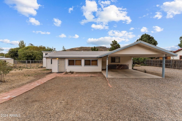 ranch-style house featuring a carport