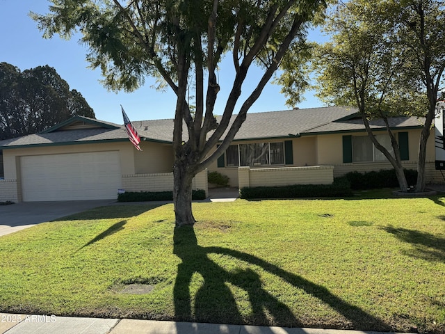 ranch-style house with a garage, a front yard, concrete driveway, and brick siding