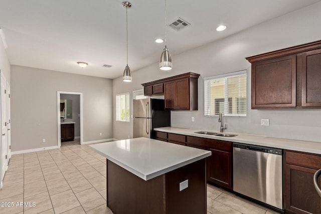 2000 N 36th St Unit 20, Phoenix, AZ 85008 - kitchen featuring appliances with stainless steel finishes, light tile patterned floors, light countertops, pendant lighting, and dark brown cabinets
