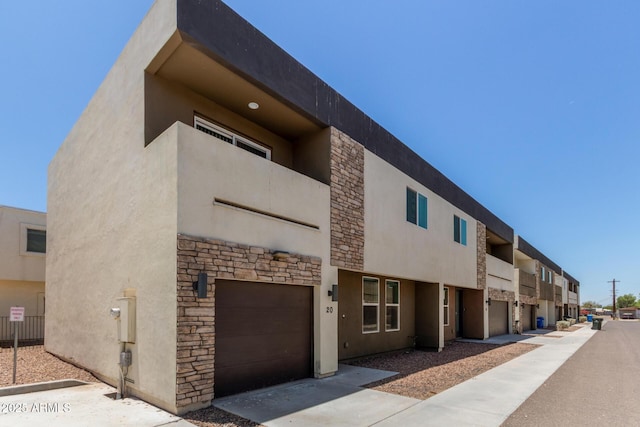 2000 N 36th St Unit 20, Phoenix, AZ 85008 - view of building exterior with an attached garage and concrete driveway