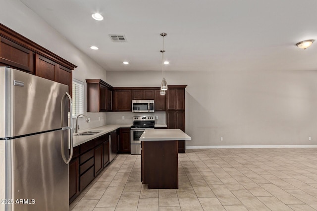2000 N 36th St Unit 20, Phoenix, AZ 85008 - kitchen with stainless steel appliances, light countertops, dark brown cabinets, a kitchen island, and light tile patterned floors