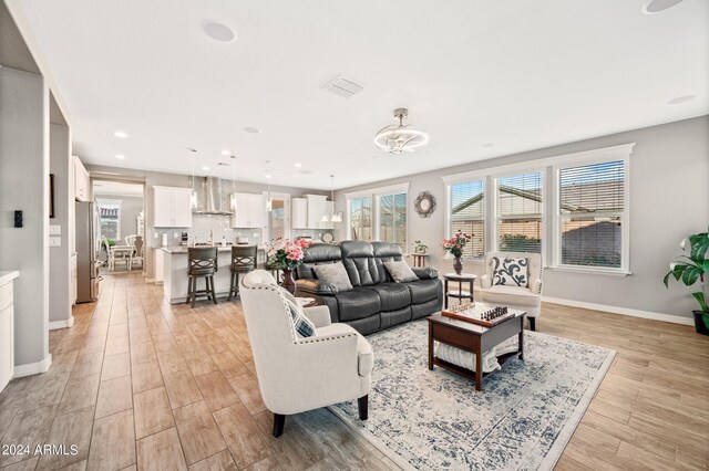 living room featuring light hardwood / wood-style floors and a wealth of natural light