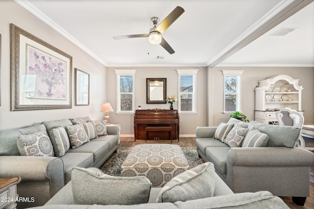 living room featuring dark wood-type flooring, a healthy amount of sunlight, and ornamental molding