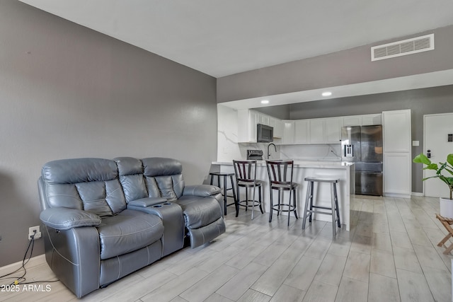 living room featuring sink