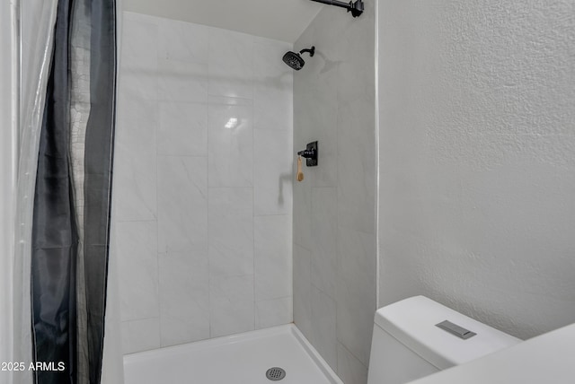 bathroom with a shower with curtain and toilet