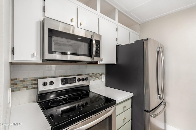 kitchen featuring white cabinetry, stainless steel appliances, and tasteful backsplash