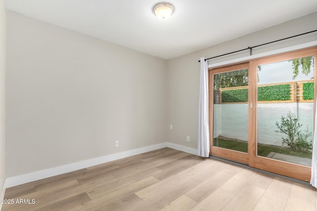 spare room with light wood-type flooring