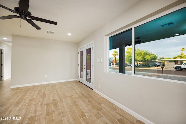 unfurnished room featuring ceiling fan, light hardwood / wood-style flooring, and french doors