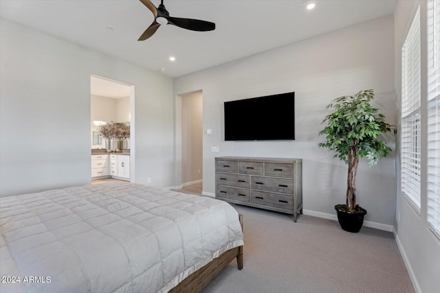 carpeted bedroom featuring ceiling fan and ensuite bathroom