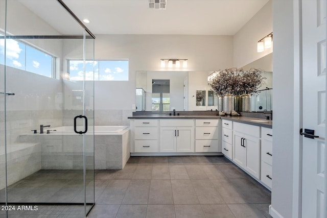 bathroom featuring tile patterned flooring, vanity, and separate shower and tub