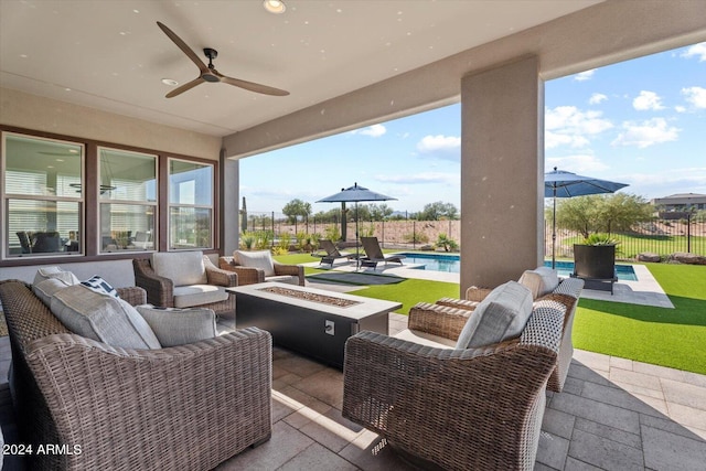 view of patio / terrace with a fenced in pool, ceiling fan, and an outdoor living space with a fire pit