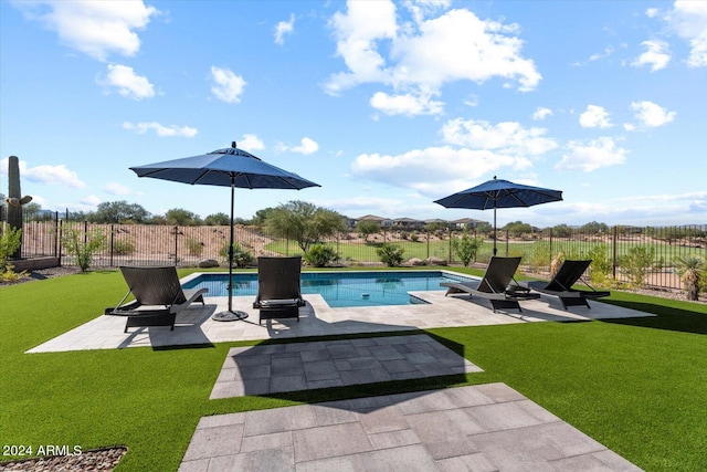 view of swimming pool featuring a yard and a patio area