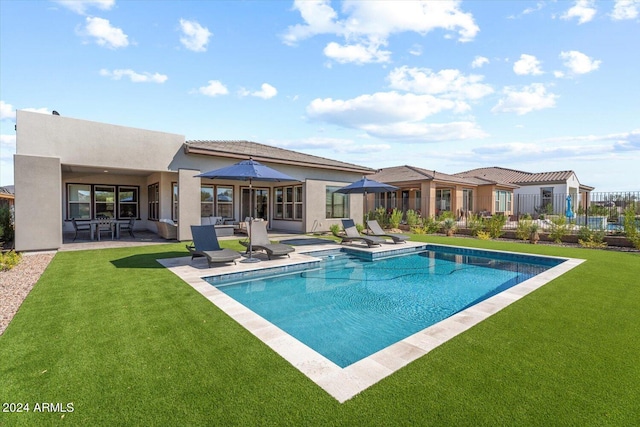 view of swimming pool featuring a yard and a patio