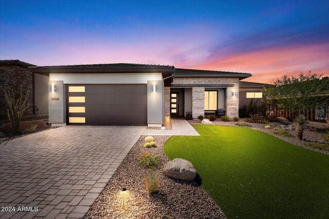 28500 N Camel Rock Ct, Rio Verde, AZ 85263 - prairie-style house with stone siding, decorative driveway, a garage, stucco siding, and a yard