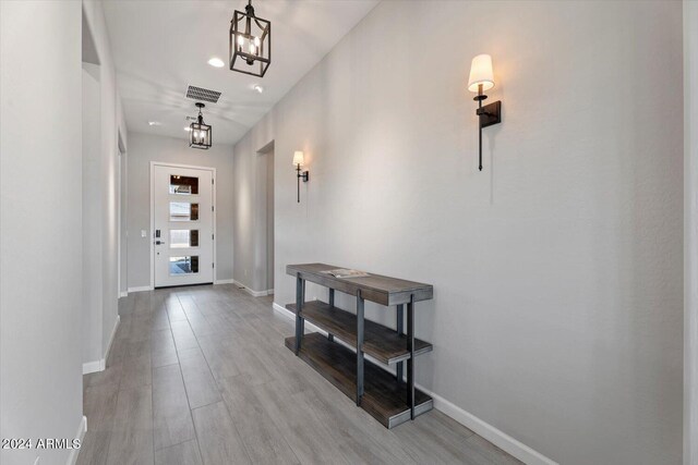 28500 N Camel Rock Ct, Rio Verde, AZ 85263 - hall with an inviting chandelier, visible vents, baseboards, and wood finished floors