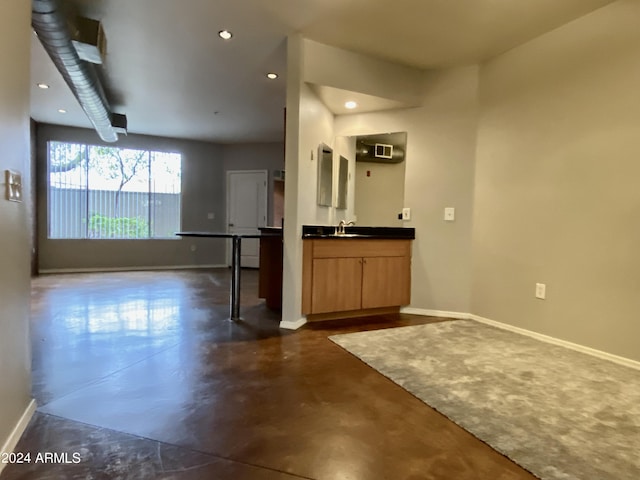 interior space with light brown cabinetry and sink