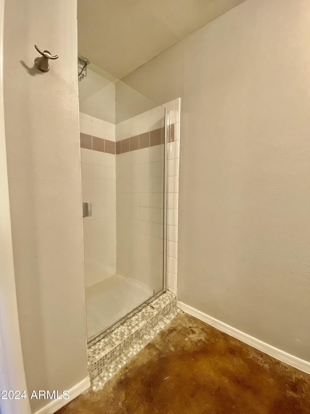 bathroom featuring concrete flooring and a shower with shower door