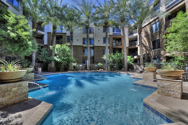 view of swimming pool with pool water feature