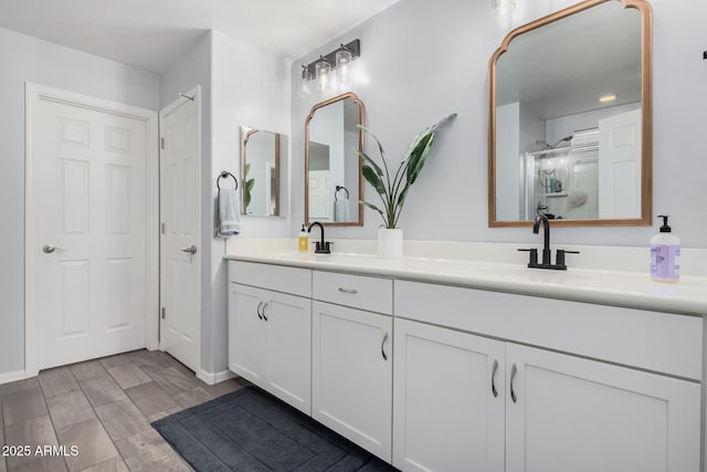 bathroom with vanity and a shower with shower door